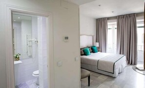 Shower, designer toiletries, hair dryer, towels