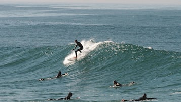 A surfer riding a wave in the ocean.