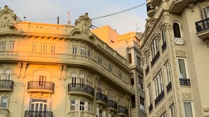 A multi-story building with ornate architectural details, including balconies with black railings and decorative moldings. - Hotel Turia Valencia (Valencia)