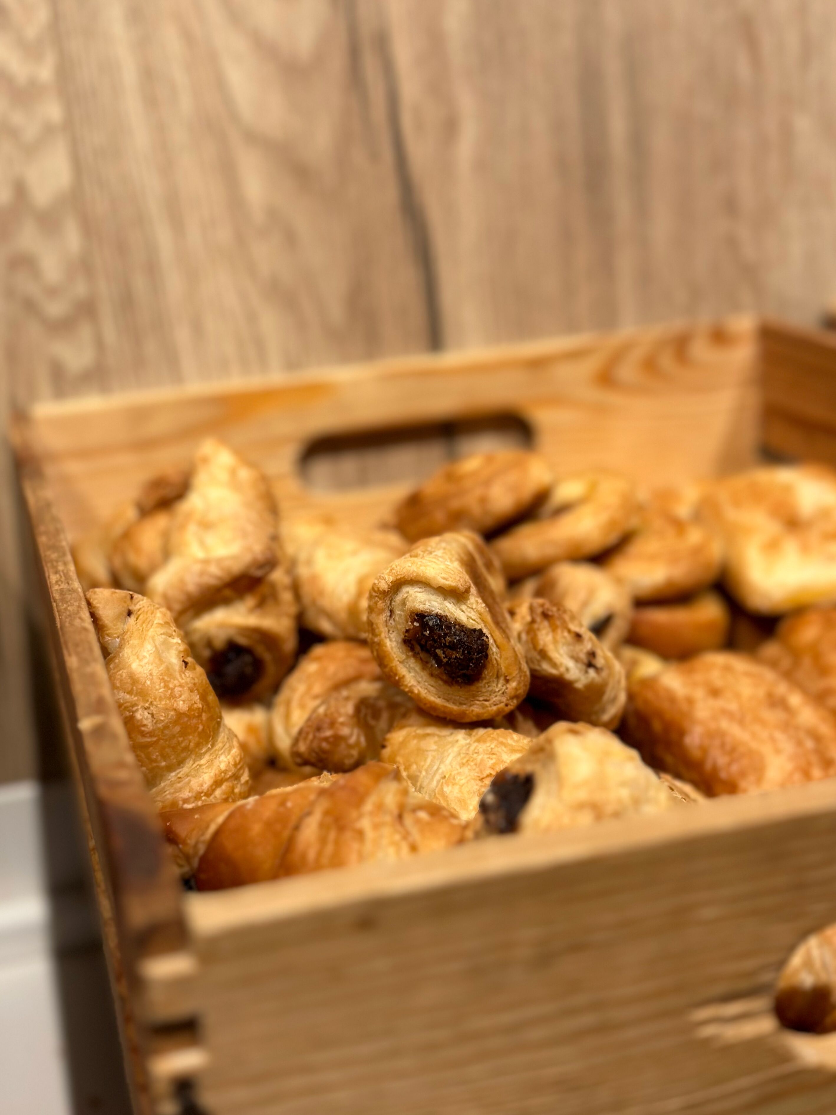 Una caja de madera llena de varios pasteles.