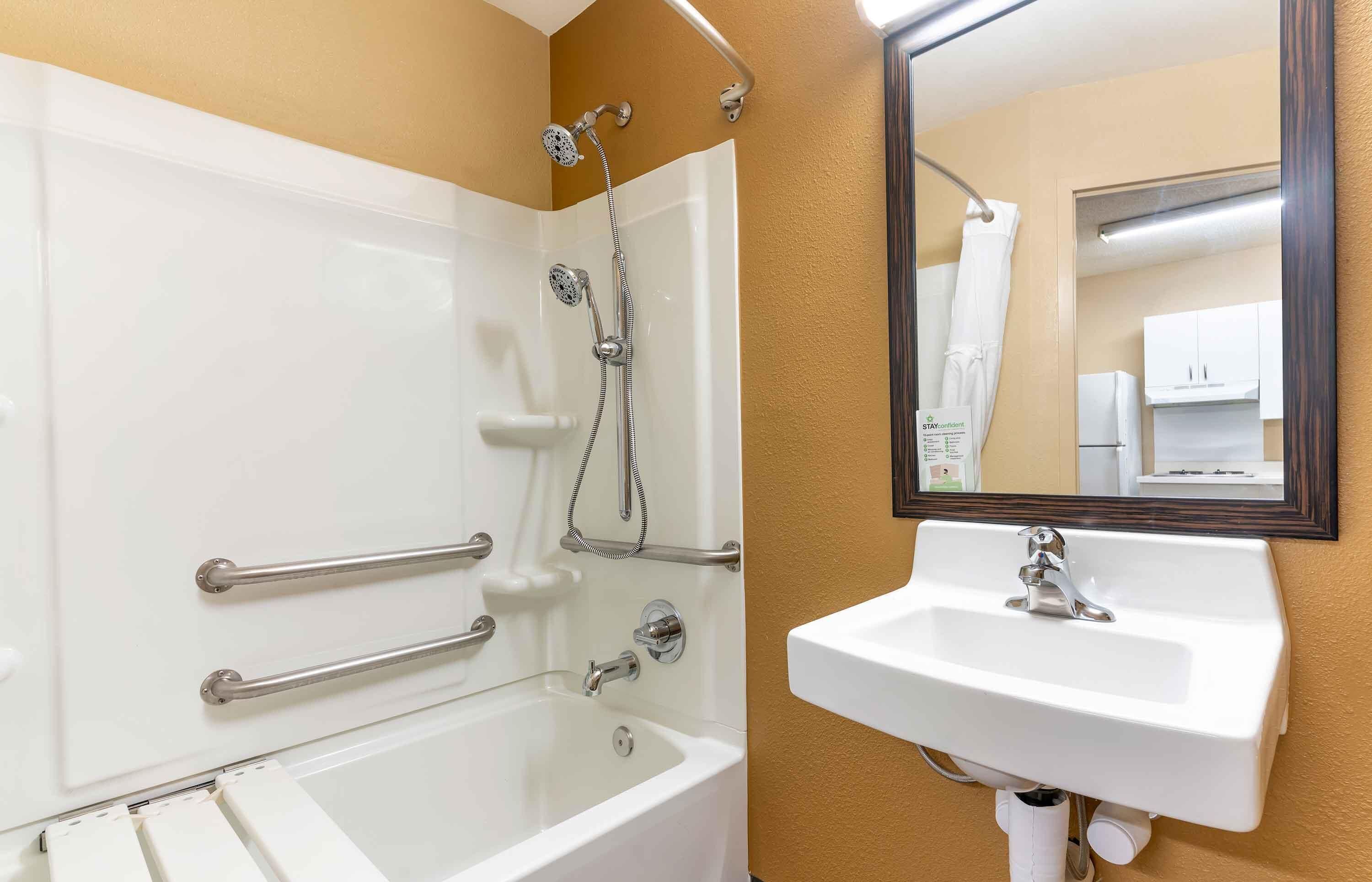 A bathroom with a bathtub, a shower, and a sink.