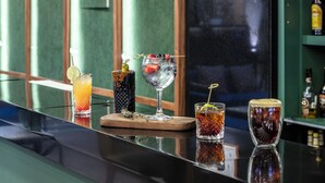 A bar with various drinks, a wooden board, and bottles in the background. - Holiday Inn Ciudad De Mexico-Trade Center by IHG (Mexico City)