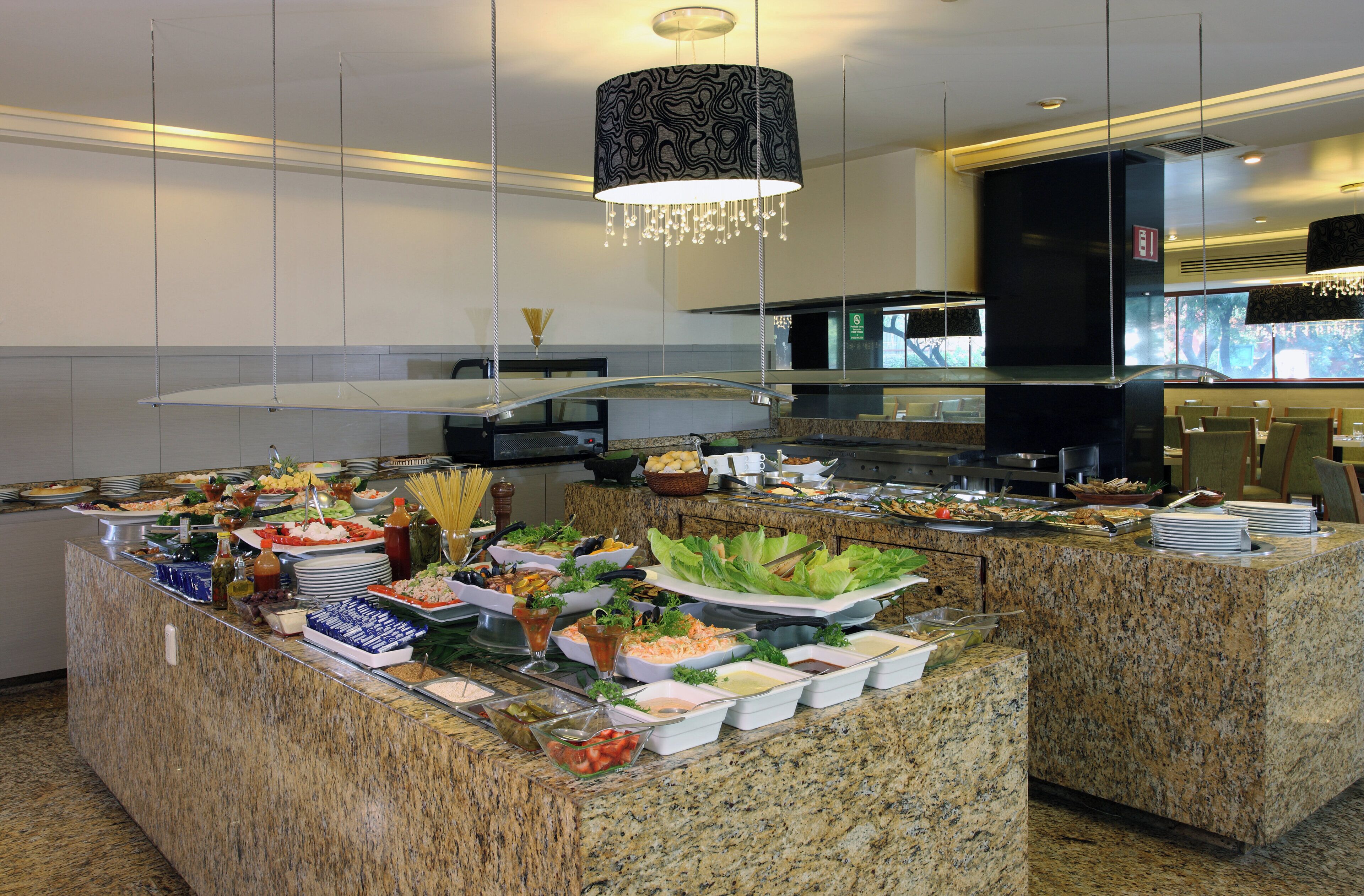 A buffet setup with various food items and condiments.
