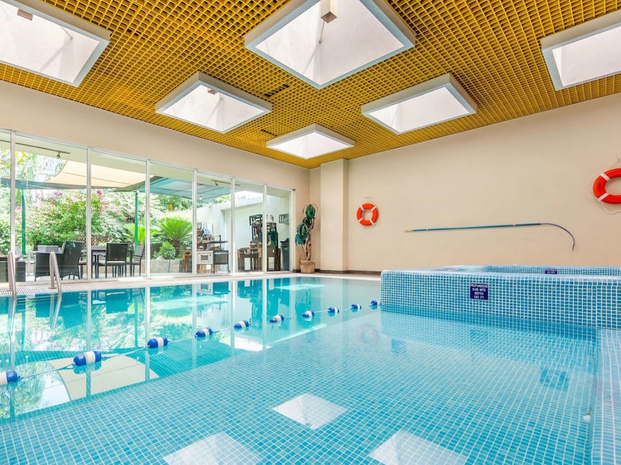 Indoor pool, open 8:00 AM to 9:00 PM, pool loungers
