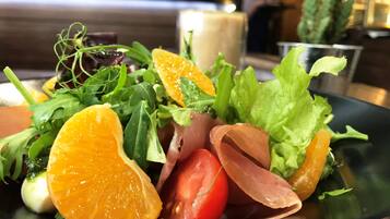 A plate of food with various vegetables and fruits.