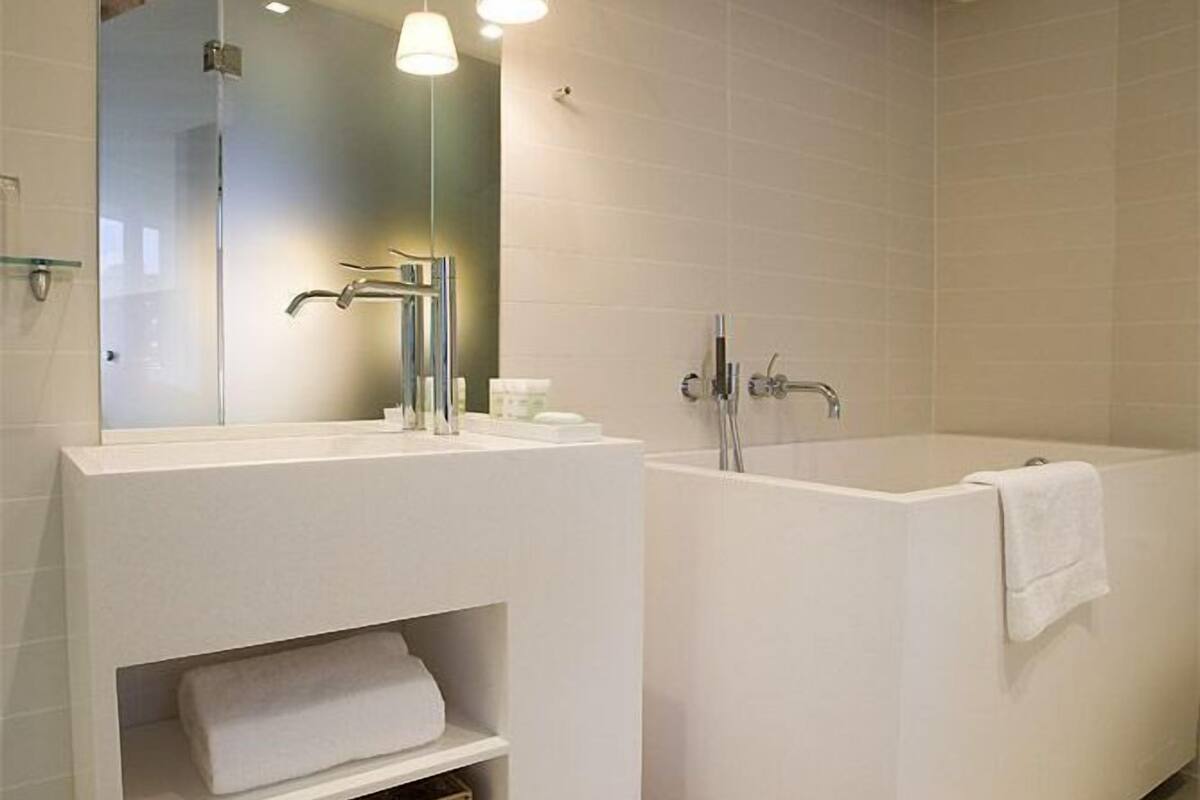 junior studio suite | bathroom | shower, hair dryer, towels