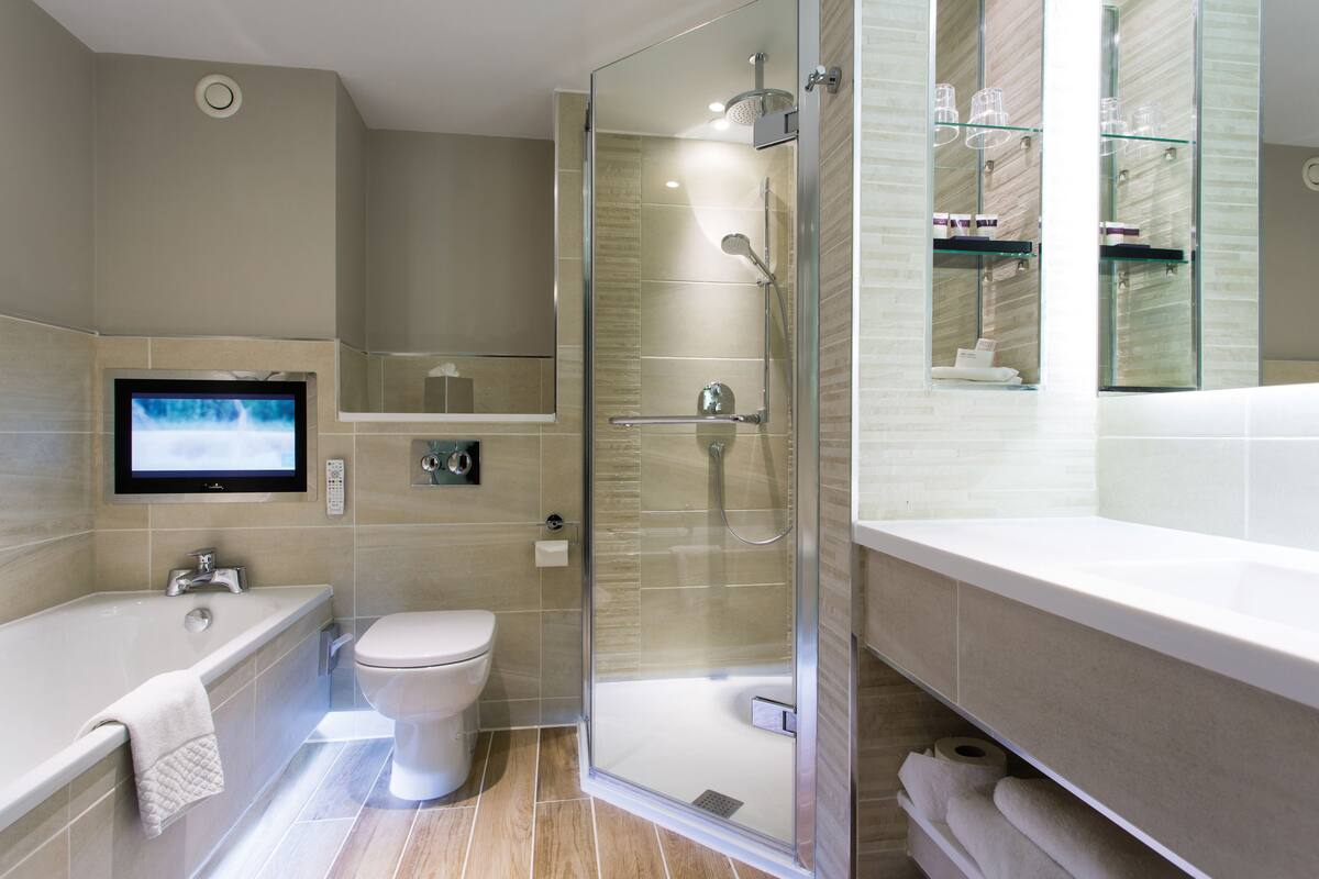 combined shower/bathtub, designer toiletries, hair dryer, bathrobes