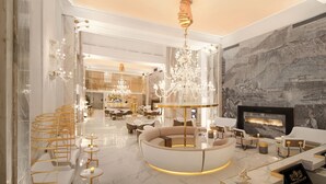 A luxurious interior with a central seating area, a bar, and a large chandelier. - Epirus Palace Congress & Spa (Ioannina)