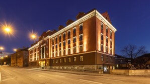 A large, historic building with multiple stories and a classic architectural style, featuring a prominent entrance and a well-lit facade. - Kreutzwald Hotel Tallinn (Tallinn)