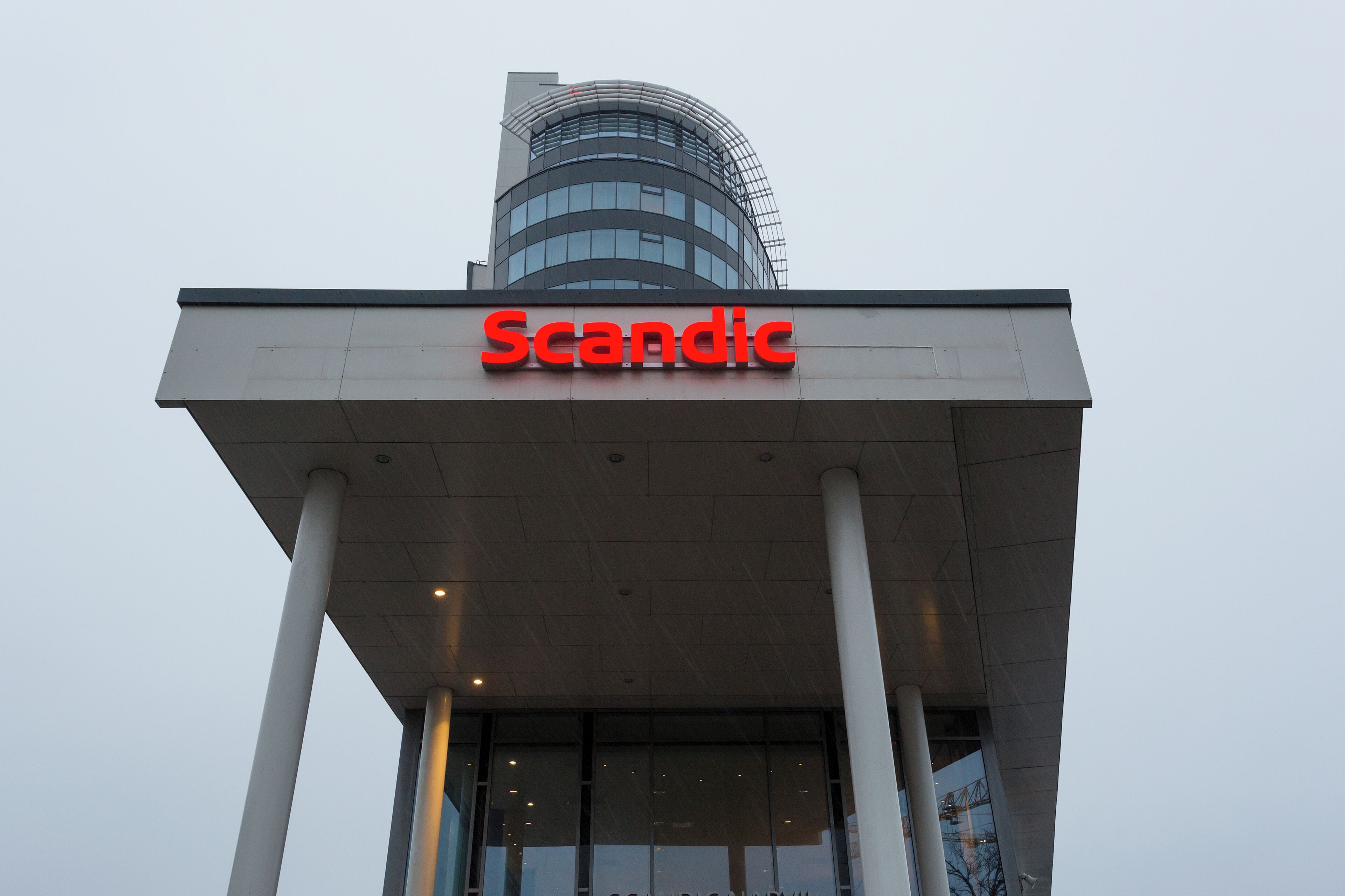 A building with a modern architectural design, featuring a prominent 'Scandic' sign.