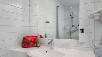 A modern bathroom with a white sink, a handheld showerhead, and a handheld hair dryer mounted on the wall.