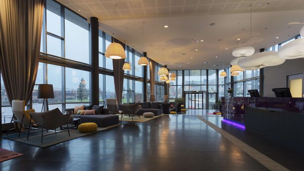 A spacious lobby with modern seating, large windows, and ambient lighting. - Scandic Narvik (Narvik)