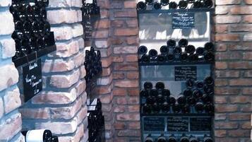 A wine cellar with bottles arranged on shelves and in wooden crates.
