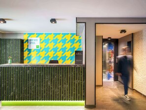 Step into style at our reception area, featuring a houndstooth patterned wall and sleek reception desk.