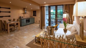 A modern living room with a dining area, a kitchen, and a large window with curtains. - Hotel Orcagna (Florence)