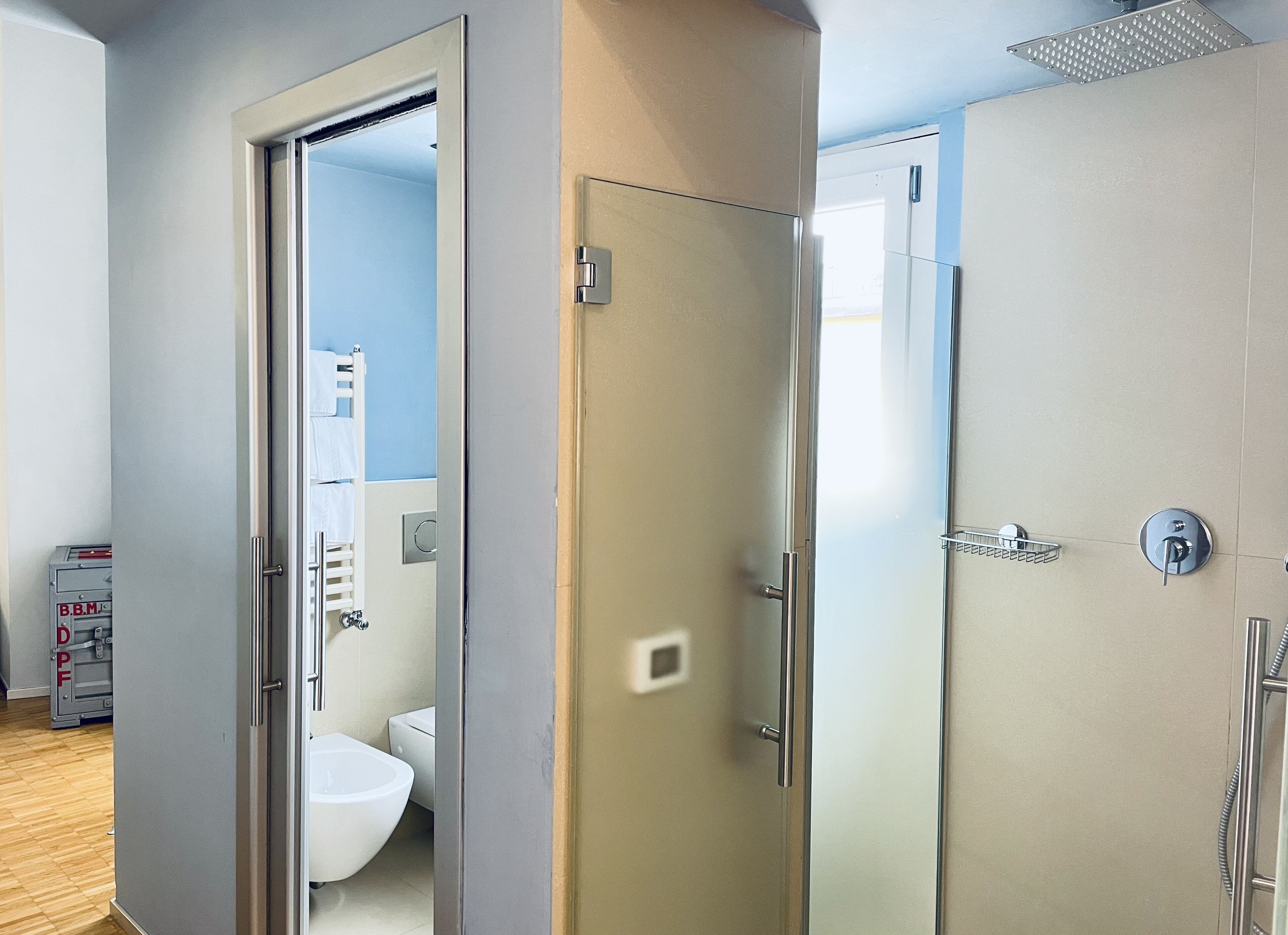 A modern bathroom with a toilet, bidet, and shower.