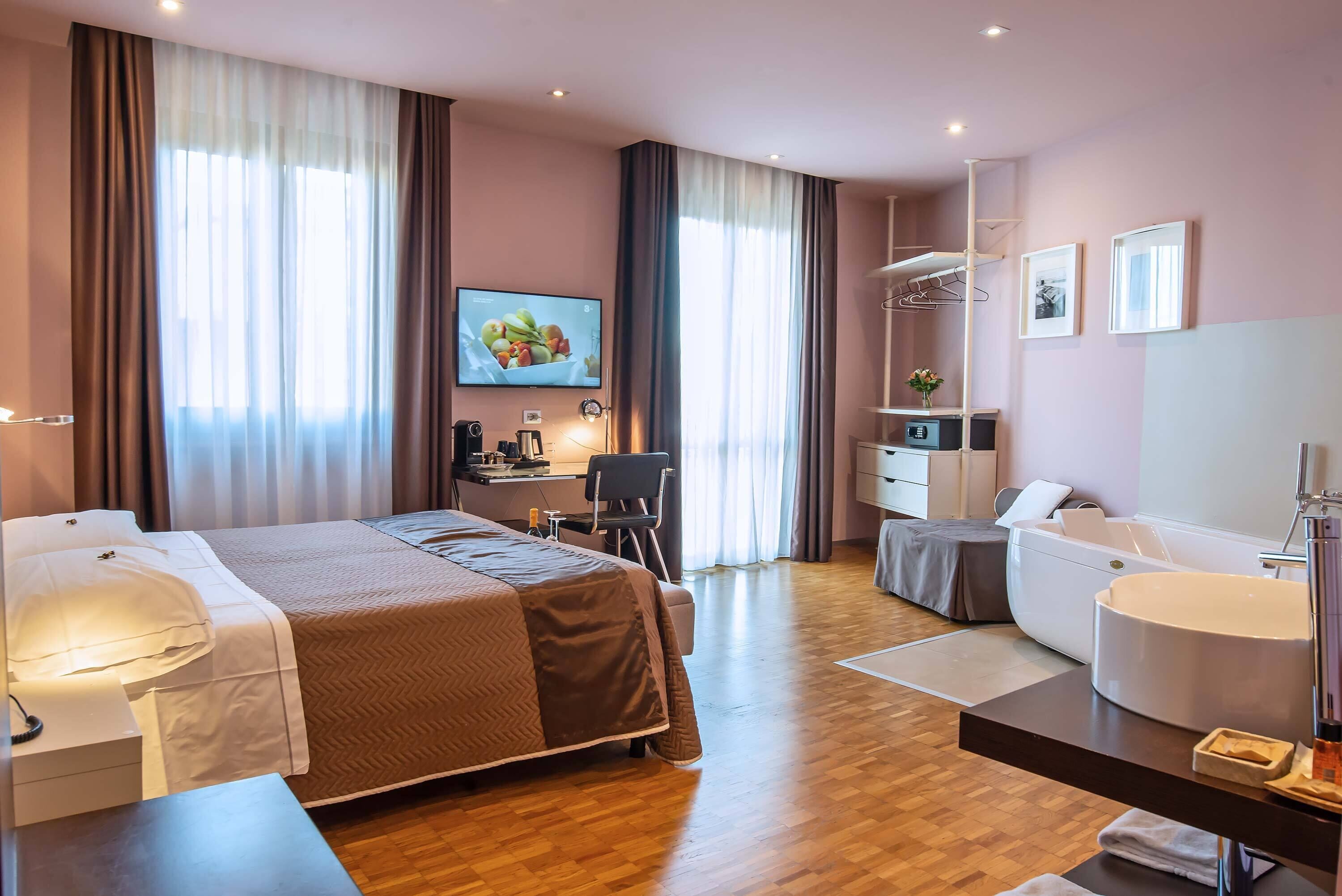 superior double room, jetted tub | minibar, in-room safe, desk, laptop workspace