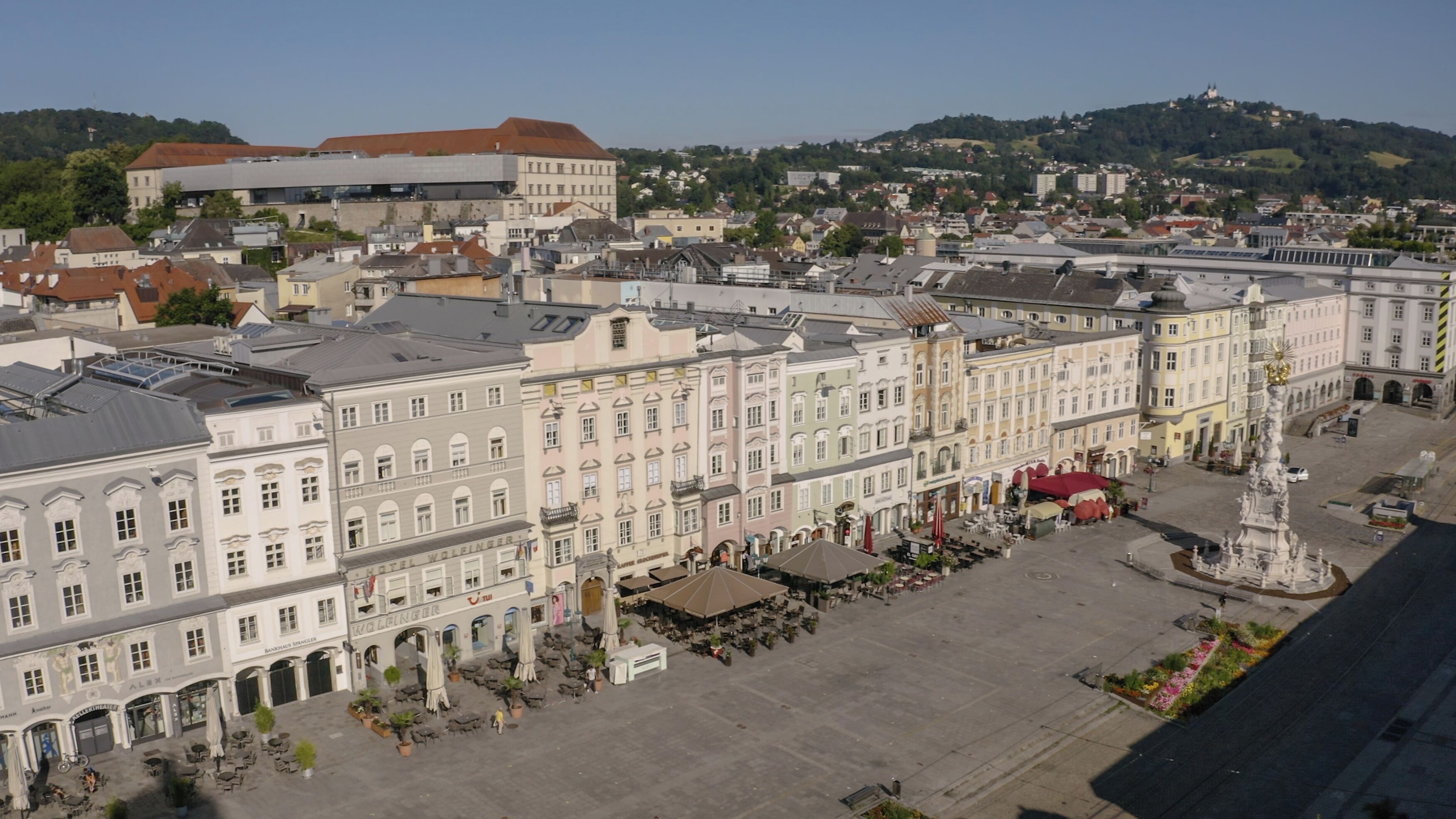 A historic building with a central courtyard, outdoor seating, and a fountain.