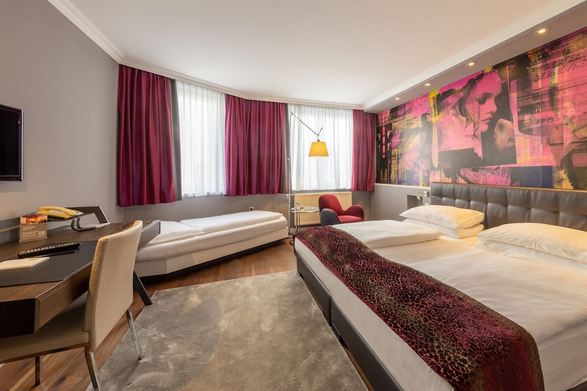 Deluxe trippelrum | Allergitestade sängkläder, minibar och värdeförvaringsskåp på rummet