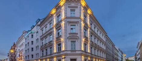 A historic hotel with classical architecture, multiple floors, and a corner location.