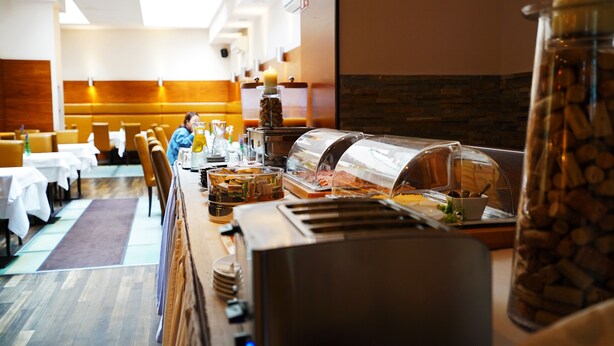 A buffet setup with various food items and a self-service station. - Hotel Marc Aurel - Vienna City Center (Vienna)