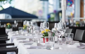 A dining table set with wine glasses, water glasses, and a small potted plant. - Hotel Marc Aurel - Vienna City Center (Vienna)