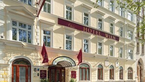 A classical building with a sign reading "Hotel Wien" and a large arched entrance. - Austria Classic Hotel Wien (Vienna)