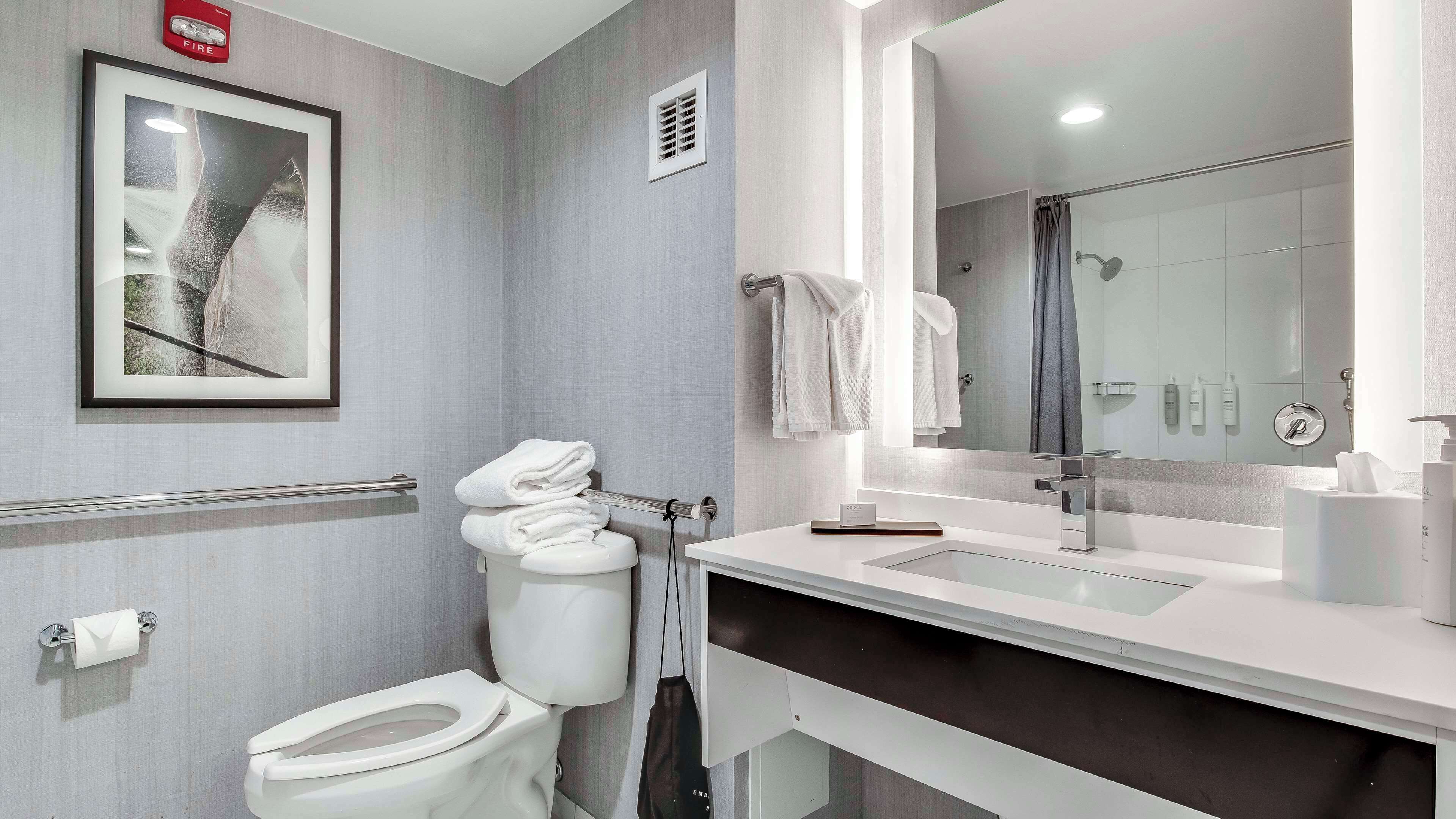 combined shower/bathtub, designer toiletries, hair dryer, towels