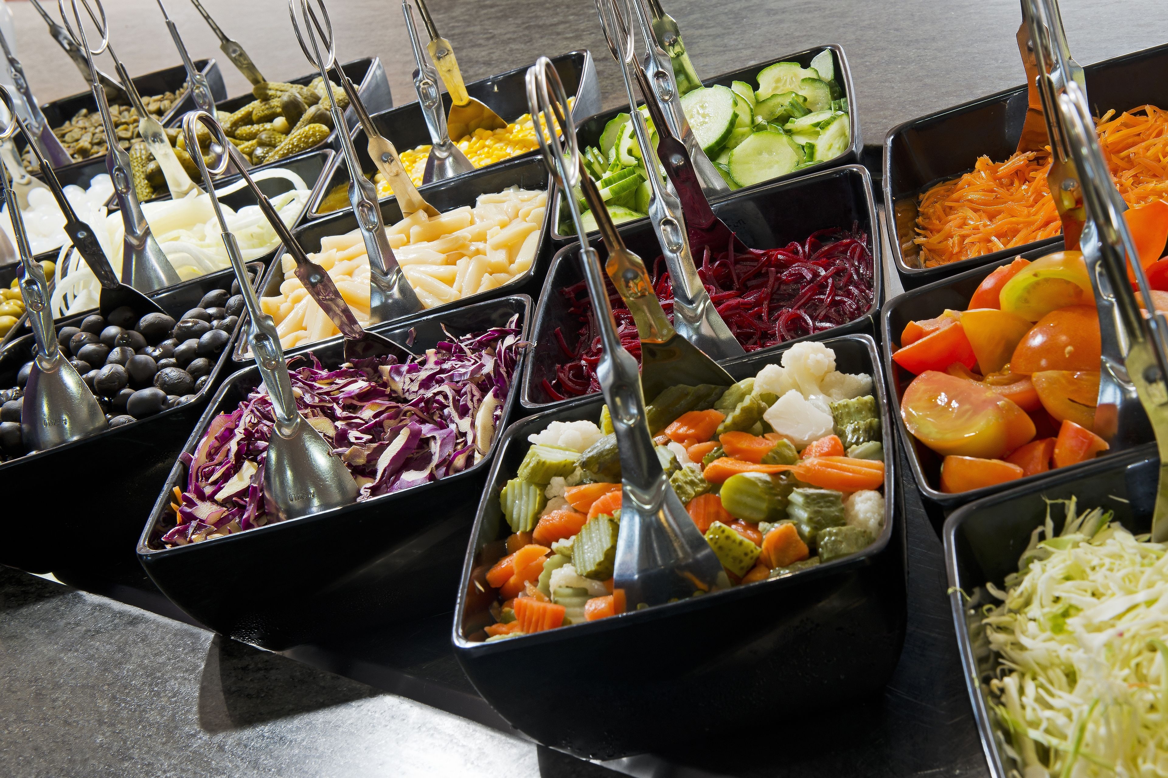Un buffet proposant une variété de plats et d’ustensiles de service.