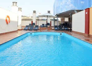 Seasonal outdoor pool, open 11:00 AM to 8:00 PM, pool umbrellas