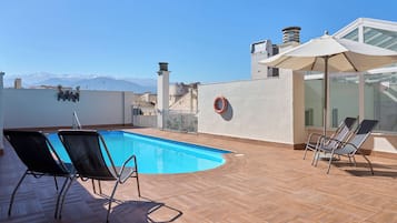 Seasonal outdoor pool, open 11:00 AM to 8:00 PM, pool umbrellas