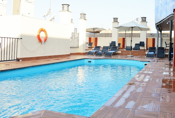 Seasonal outdoor pool, open 11:00 AM to 8:00 PM, pool umbrellas