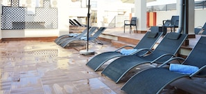 Seasonal outdoor pool, open 11:00 AM to 8:00 PM, pool umbrellas