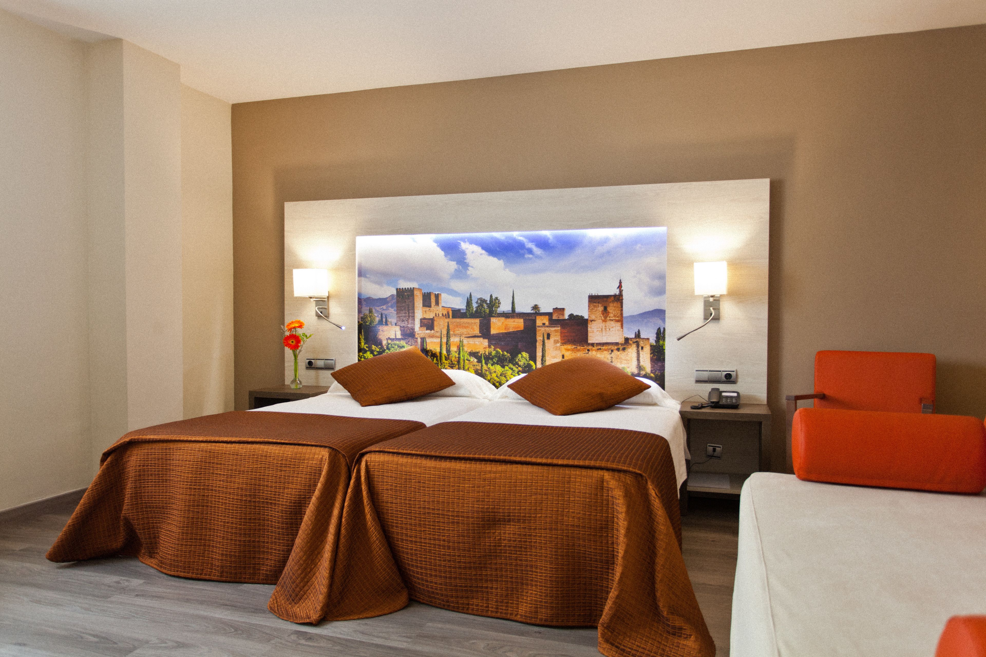 A hotel room with two beds, a large mirror, and a cityscape view.