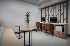 A modern hotel room with a desk, two chairs, a computer, a plant, and a bed. - Homewood Suites by Hilton Cleveland-Solon (Solon)