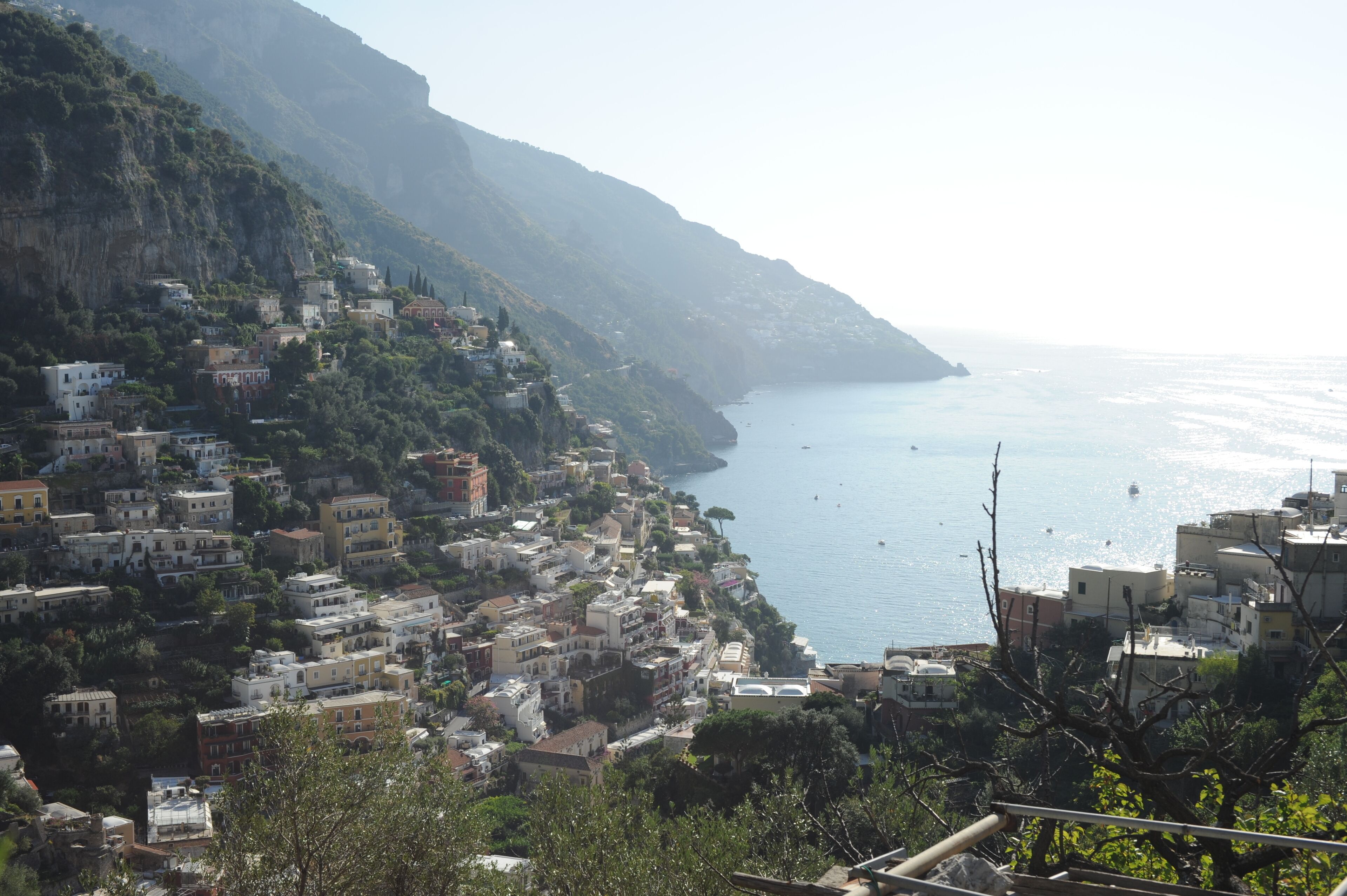 A coastal town with buildings along the hillside and a view of the sea.