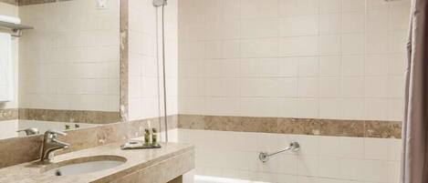 A bathroom with a bathtub, a sink, and a shower.