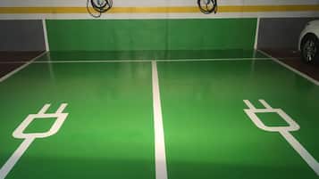 A parking area with green flooring and white parking space markings.
