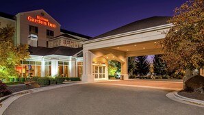 A Hilton Garden Inn with a large entrance, well-lit exterior, and landscaped surroundings. - Hilton Garden Inn Boise Spectrum (Boise)