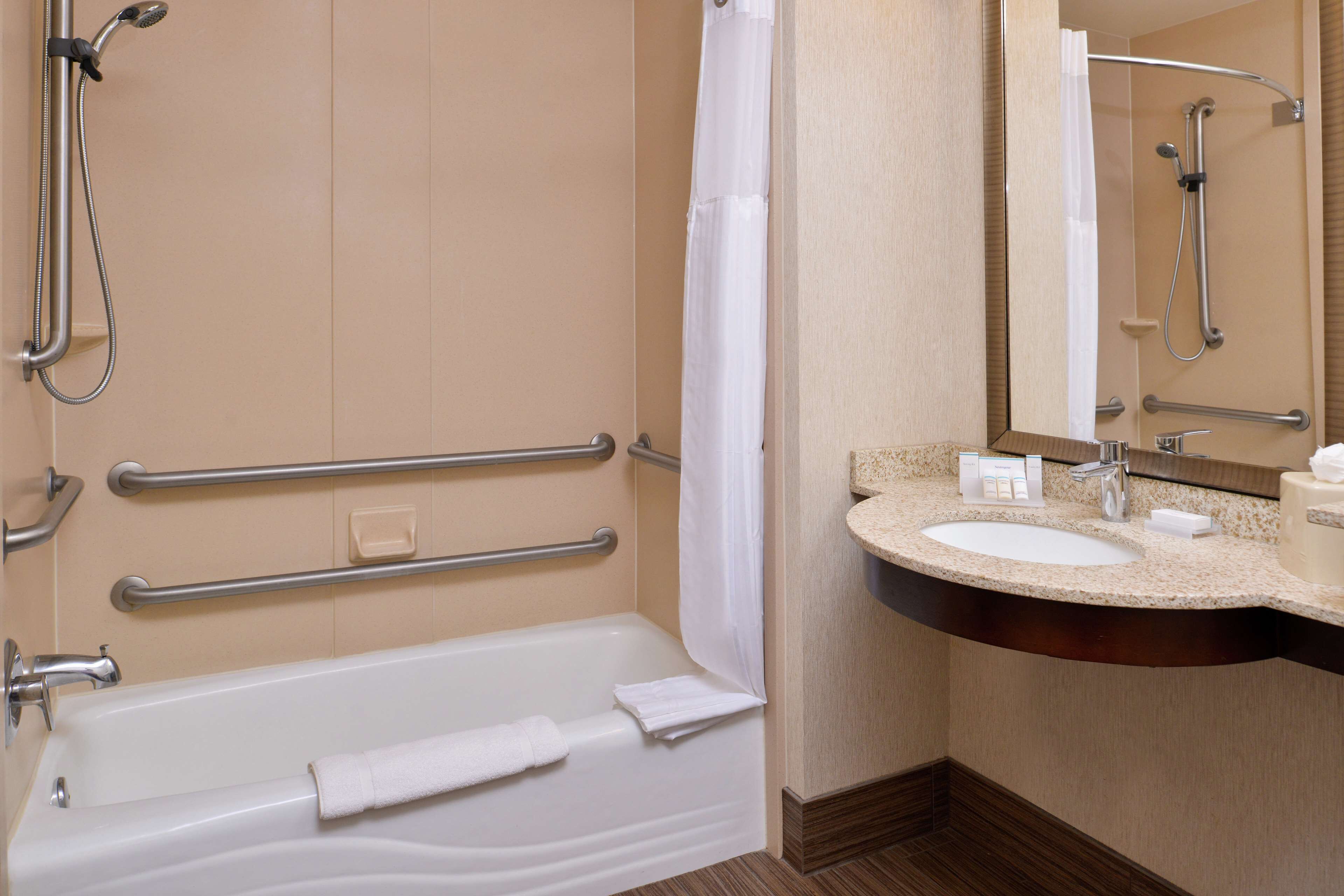 A modern bathroom with a bathtub, a sink, and a shower.
