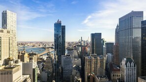 A high-rise cityscape with modern skyscrapers, a river, and a bridge. - M Social Hotel New York Downtown  (New York)