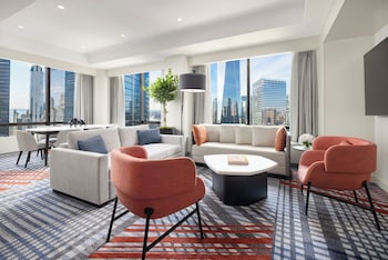 M Social Suite | Living area | 55-inch LED TV with cable channels, first-run movies, pay movies at M Social Hotel New York Downtown 