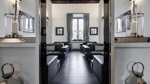 A modern hotel lobby with a central seating area, framed pictures on the walls, and a large window with curtains. - LHP Hotel River & SPA (Florence)