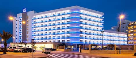A multi-story hotel with a modern design, featuring a prominent 'Best' sign on the top left.
