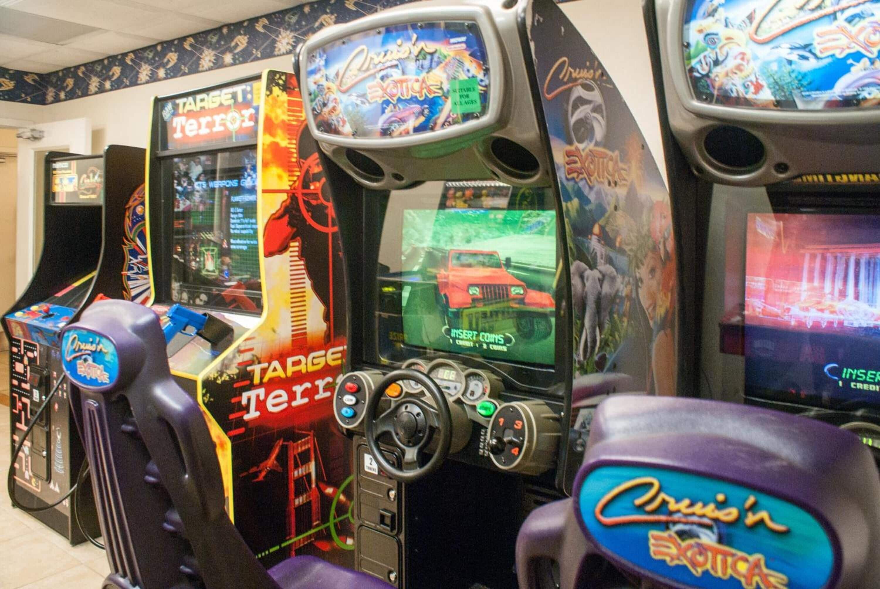 Arcade machines with game titles like "Target Terror" and "Cruisin' Extrac".