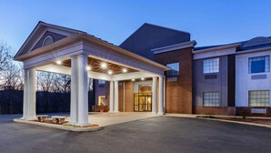 A hotel entrance with a covered patio, brick facade, and large windows. - Days Inn by Wyndham Altavista (Altavista)