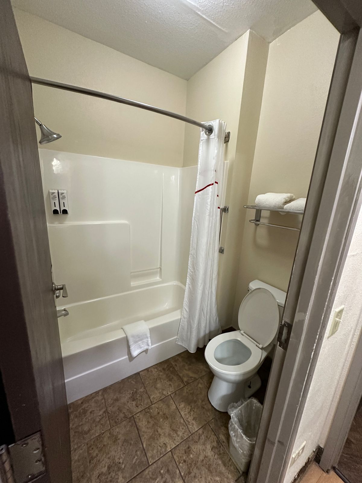 Ein Badezimmer mit Badewanne, Toilette und Duschvorhang.
