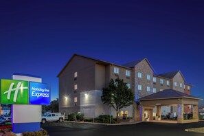 A Holiday Inn Express hotel with a modern design, multiple entry points, and a parking lot. - Holiday Inn Express Columbus - Ohio Expo Center by IHG (Columbus)