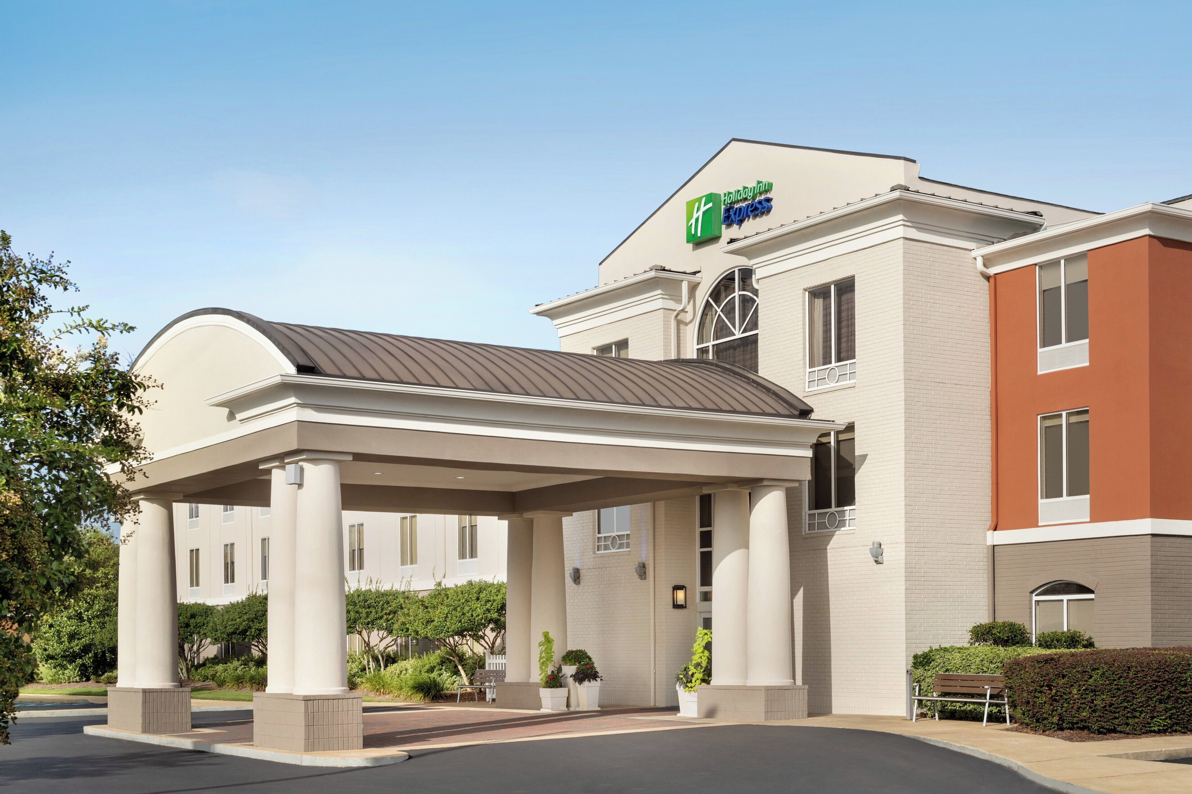A Holiday Inn Express hotel with a covered entrance and a brick facade.