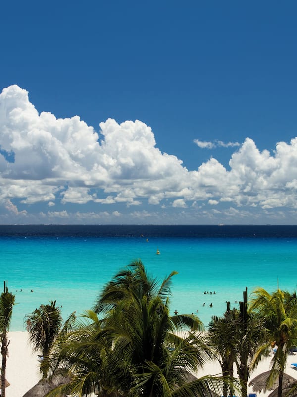 On the beach, white sand, sun loungers, beach umbrellas